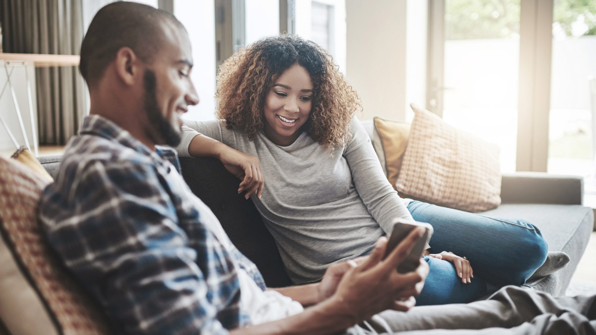  happy couple looking at a mobile phone