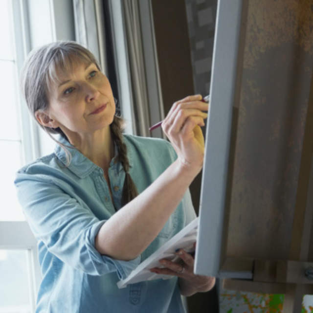 Woman painting at an easel