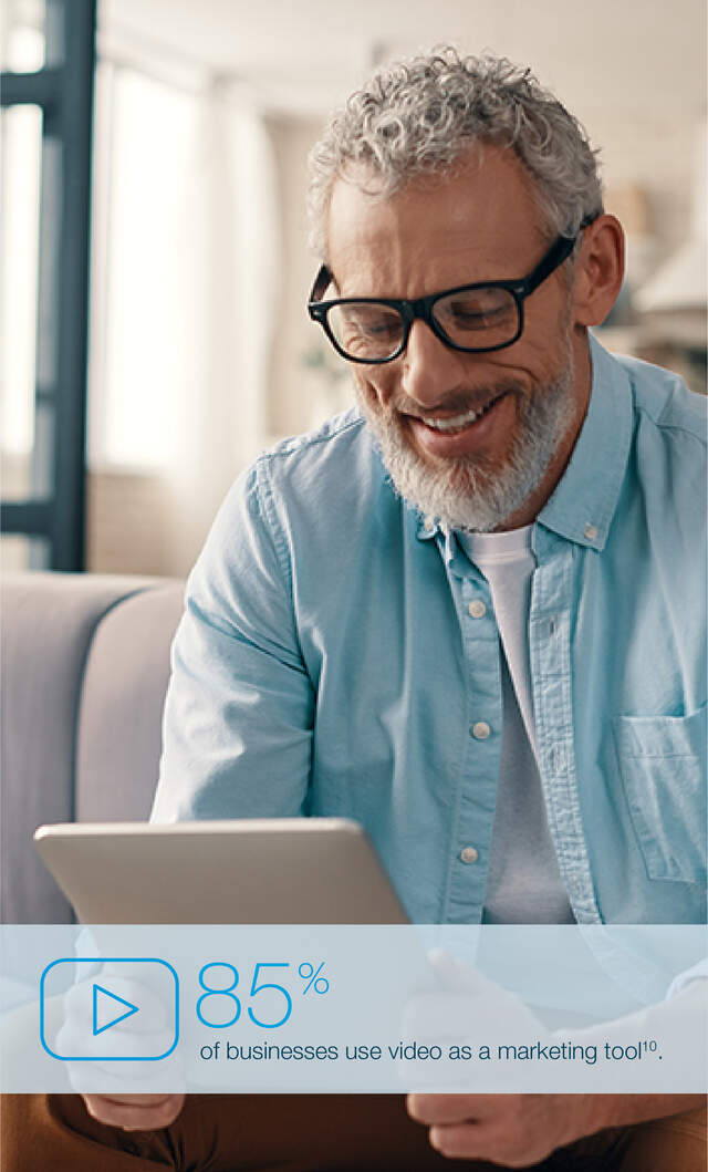 Male blue shirt reading ipad