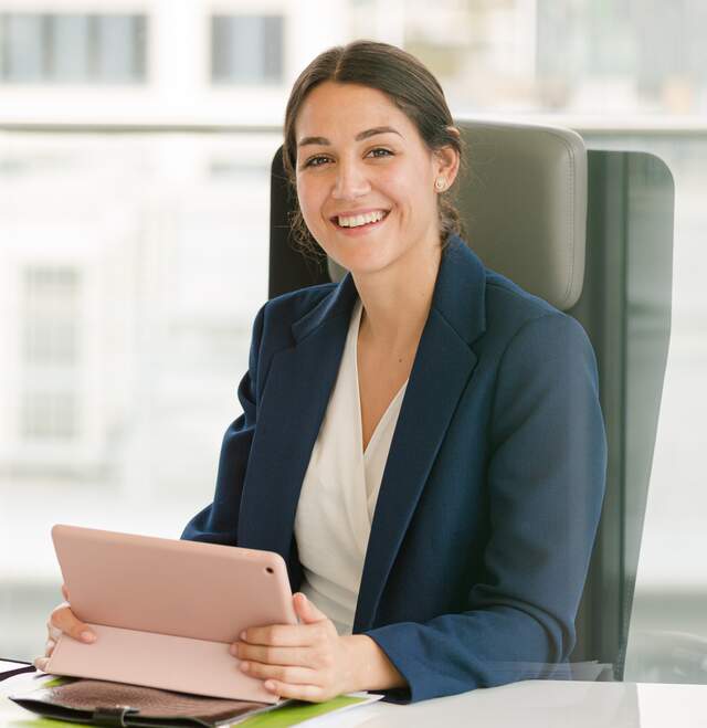 Female on ipad smiling